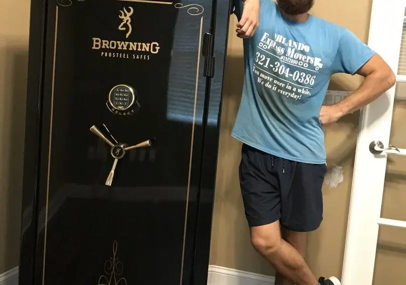 Orlando Express Movers crew member beside a Browning ProSteel gun safe in an Orlando home