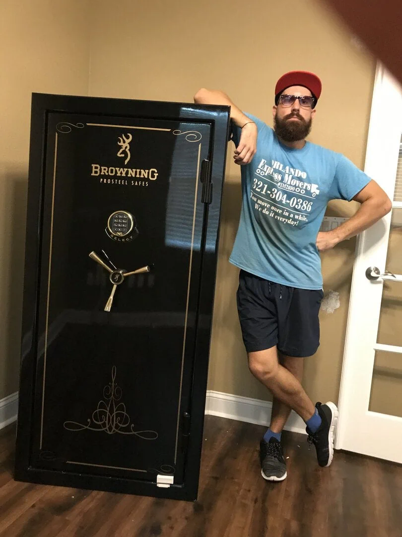 Orlando Express Movers crew member beside a Browning ProSteel gun safe in an Orlando home