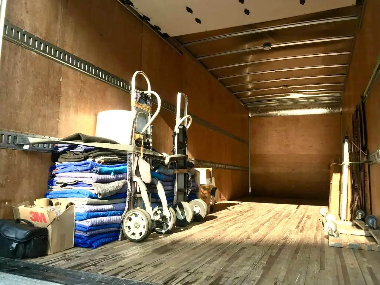 Inside an Orlando Express Movers truck with moving blankets, straps and dollies ready for a small load move